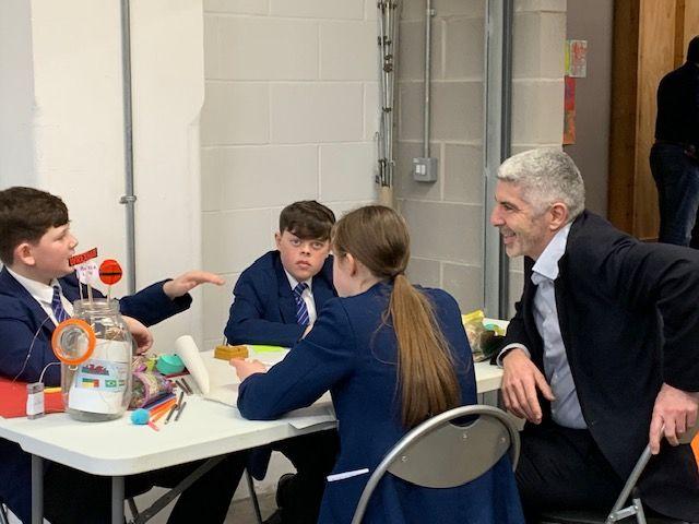 Future Generations Commissioner Derek Walker speaks with school pupils from Ysgol Rhosnesni.